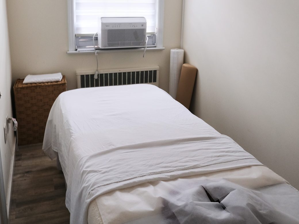 A quiet treatment room with a prepared table at Haram